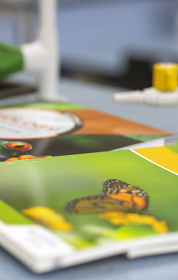 A close-up of science textbooks, including a biology book with a butterfly on the cover, resting on a laboratory bench with gas taps in the background. A close-up of science textbooks, including a biology book with a butterfly on the cover, resting on a laboratory bench with gas taps in the background.